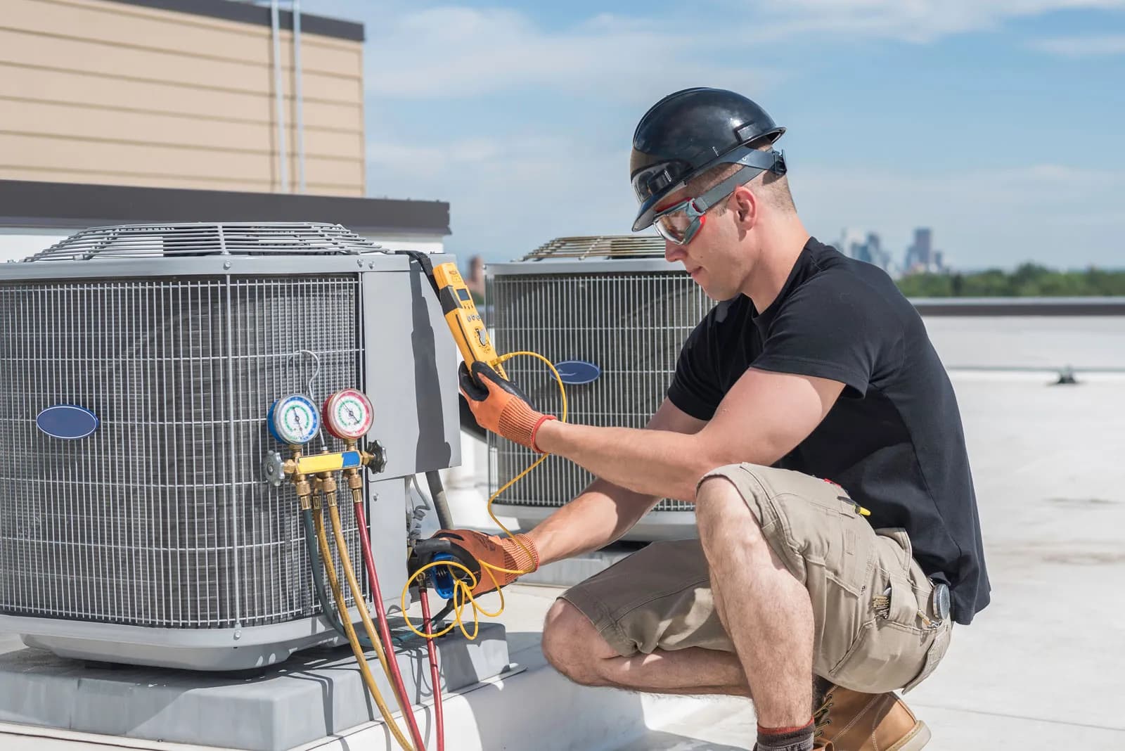 Technician performing HVAC maintenance on rooftop